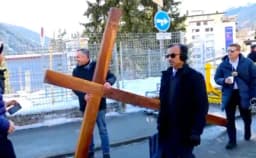 Thumbnail for Pastor carries life-size cross outside WEF, urging attendees to 'turn back to Christianity'