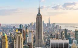 Thumbnail for Empire State Building lit up in shining gold and white in honor of Pope Leo XIV